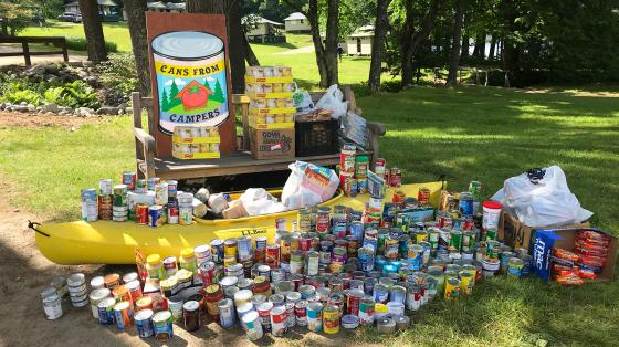 canned goods stacked in canoe and table