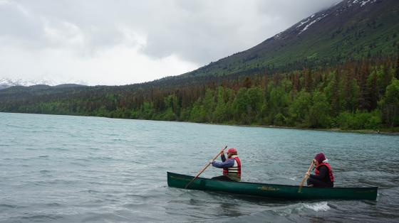 camp staff in canoe