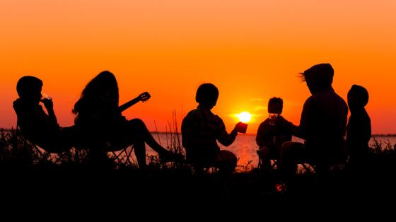 Silhouettes of group of people at sunset