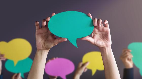 people holding talking bubbles
