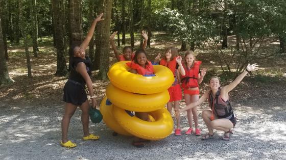 Campers and staff in lifejackets posing for camera 