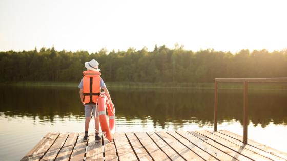 Youth wearing life jacket on boat dock