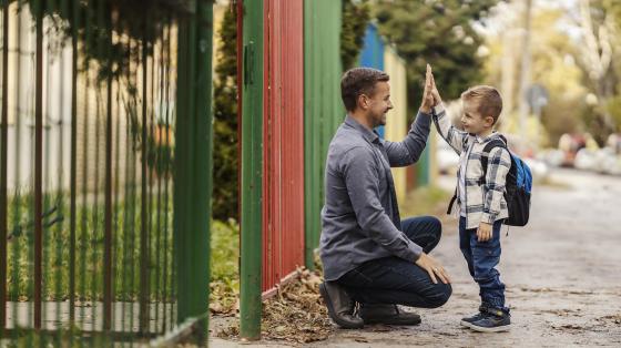 parent and child exchanging high fives
