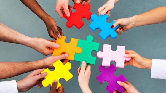 People holding puzzle pieces