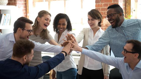 team of coworkers high fiving