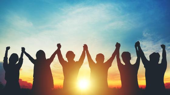 Young adults standing in sunset