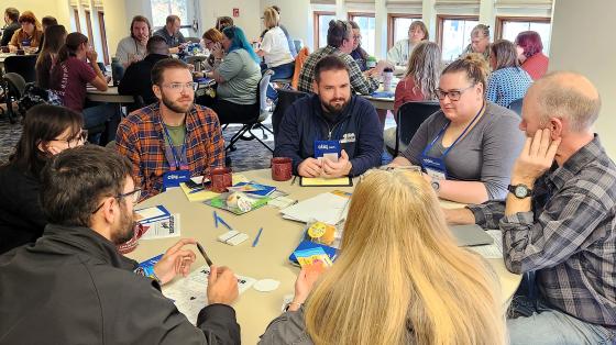 Attendees in discussion at small table