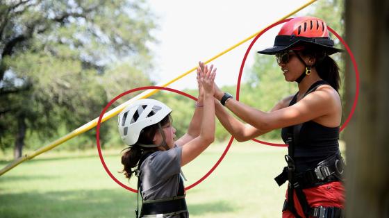 camper and counselor high-fiving