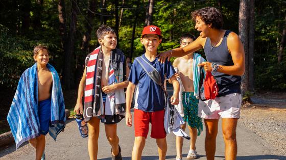 campers walking and laughing with counselor