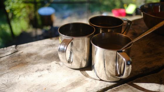 metal camping coffee cups on table
