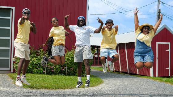 staff jumping for camera