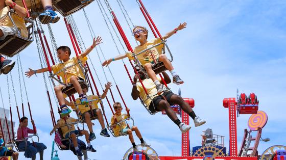 campers on carnival swings