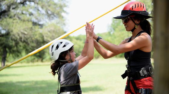 camper and staff high-five