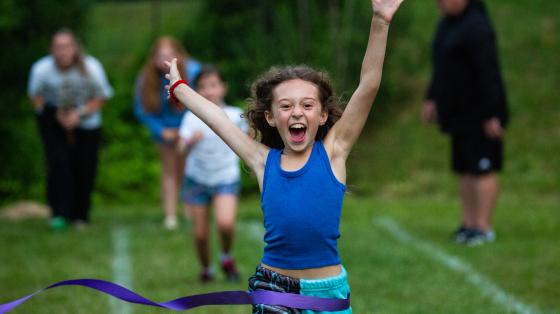Smiling Camper playing flag football