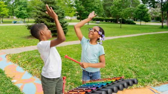 kids having fun with outdoor instrument