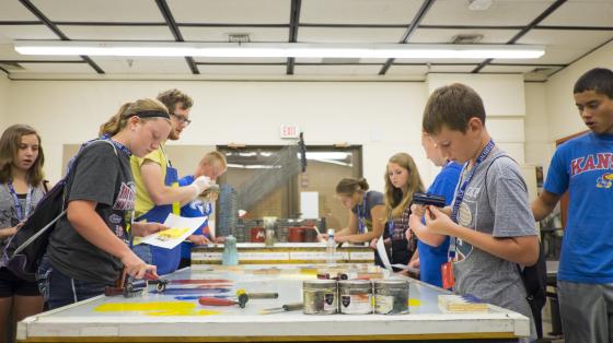 campers painting at an indoor table