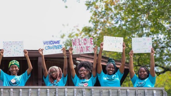 staff welcoming campers
