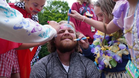 campers drawing on staff member's face