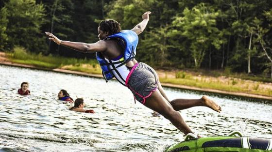 Camper jumping into water