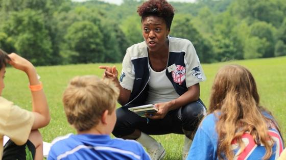 camp staff speaking to campers