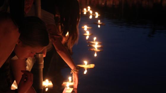 campers releasing wishing boats