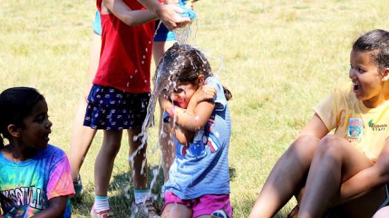 camper getting water poured over head