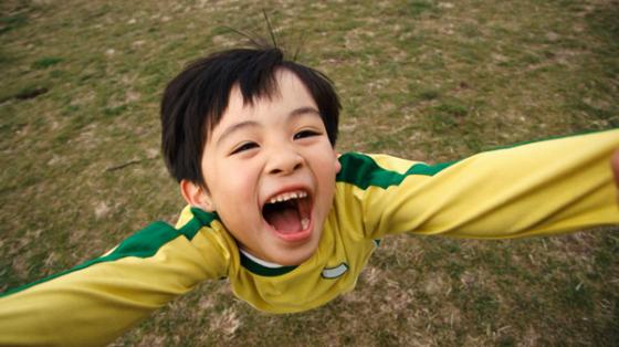 Boy reaching out with his hands in the air