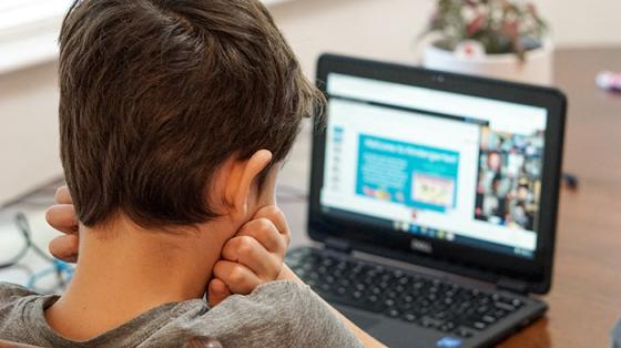 Boy looking at laptop computer 