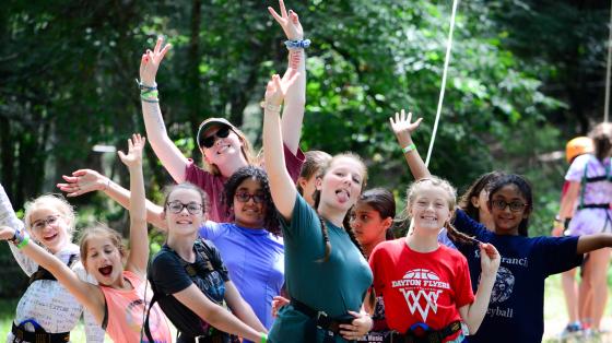 Counselor and campers posing for camera