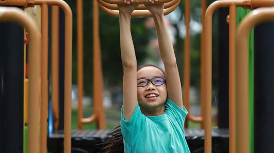 child on monkey bars