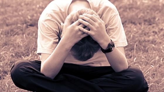 Boy sitting with head down