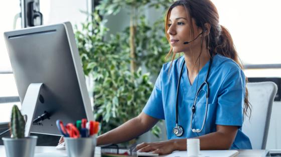 Nurse in front of computer at desk