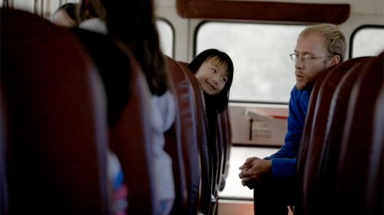 Counselor talking with kids on a bus