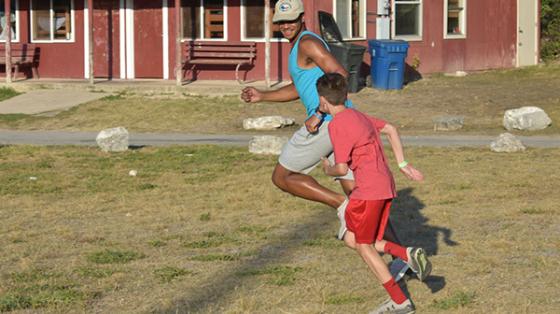 camper chasing a counselor