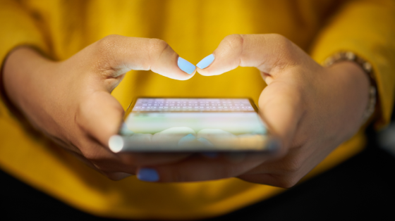 Woman typing phone message at night