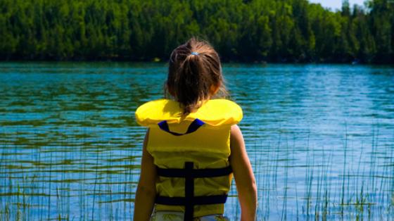 Girl in Lifejacket By Lake