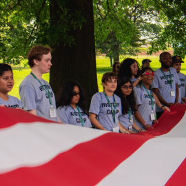 Campers and staff holding American flag