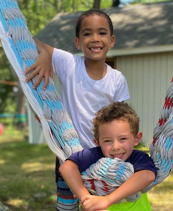 Campers next hammock smiling for camera