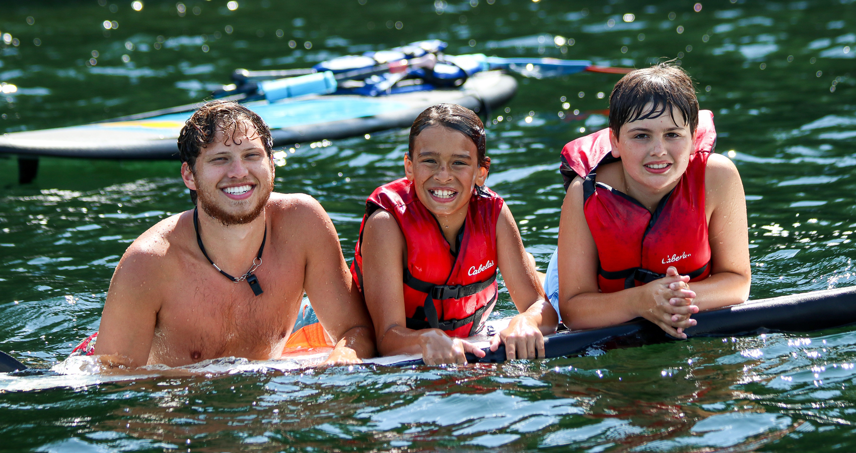 Counselor with campers in water