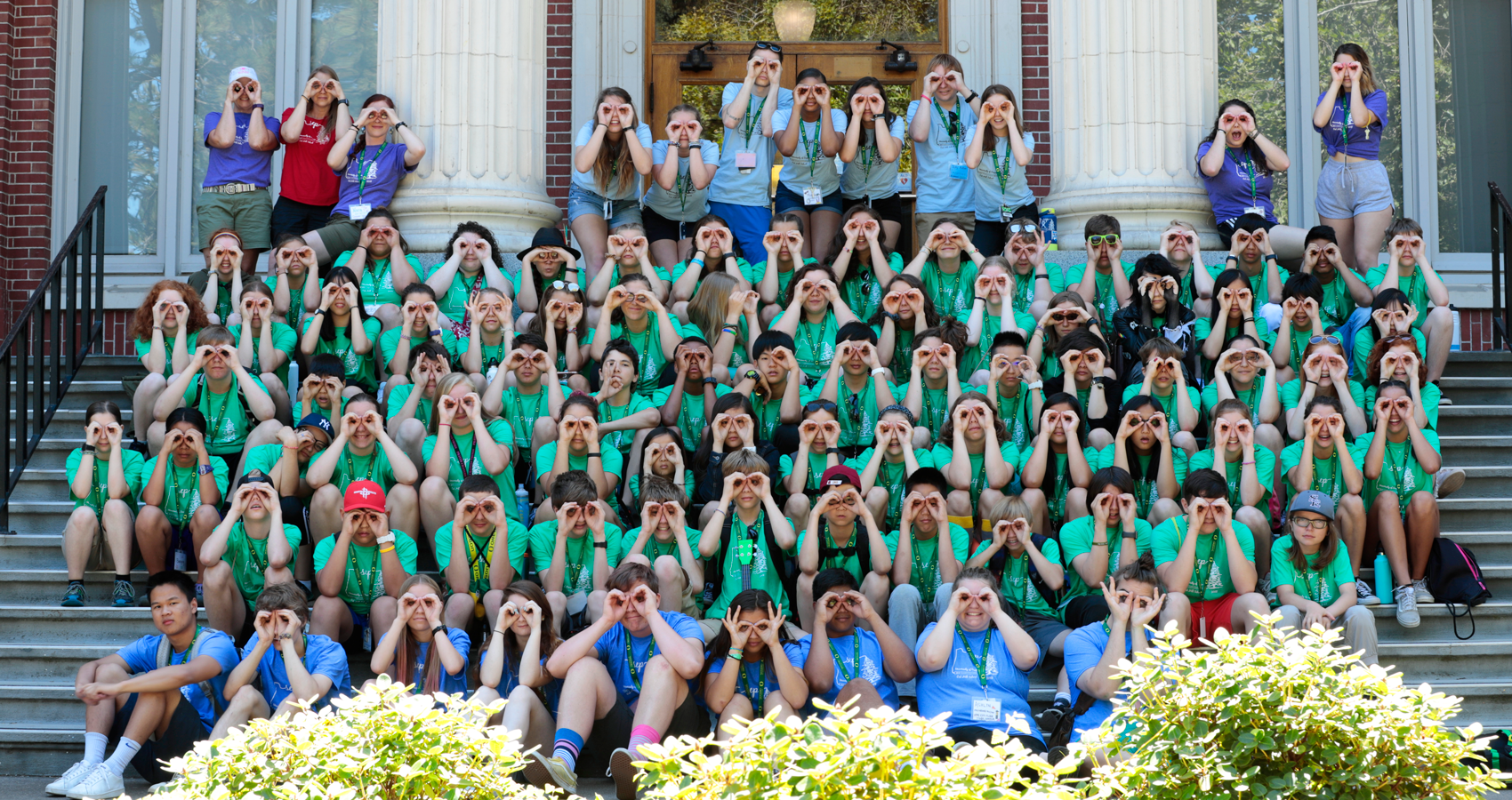 Large group of campers and staff sitting on steps