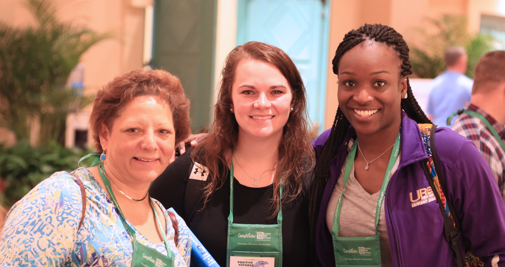 Three conference attendees smiling