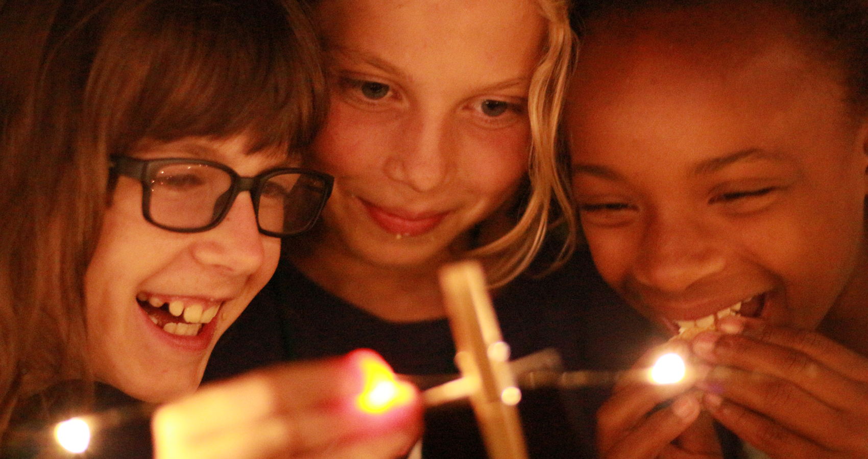 Three campers making smores