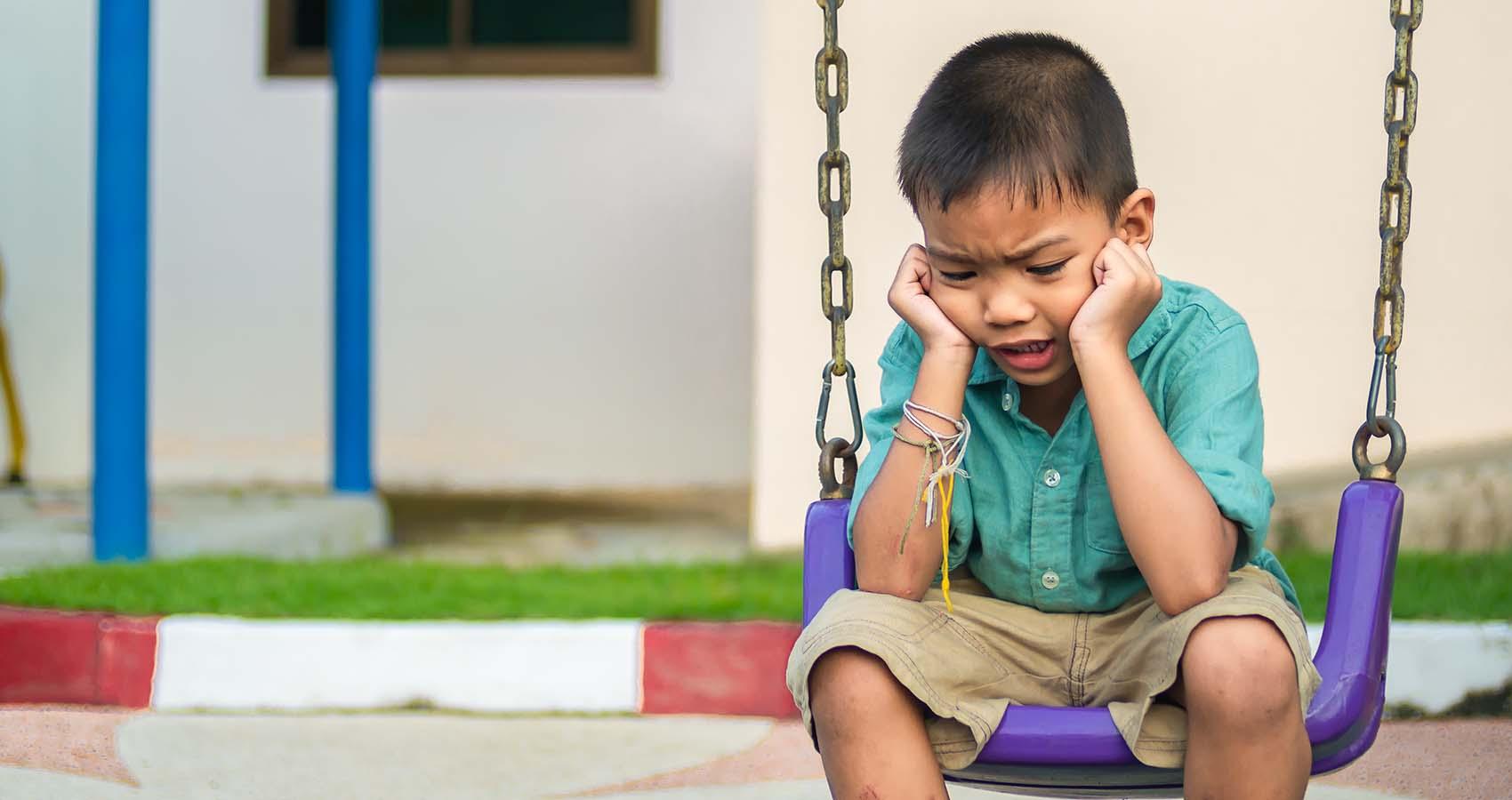 stock photo of child sitting on swing