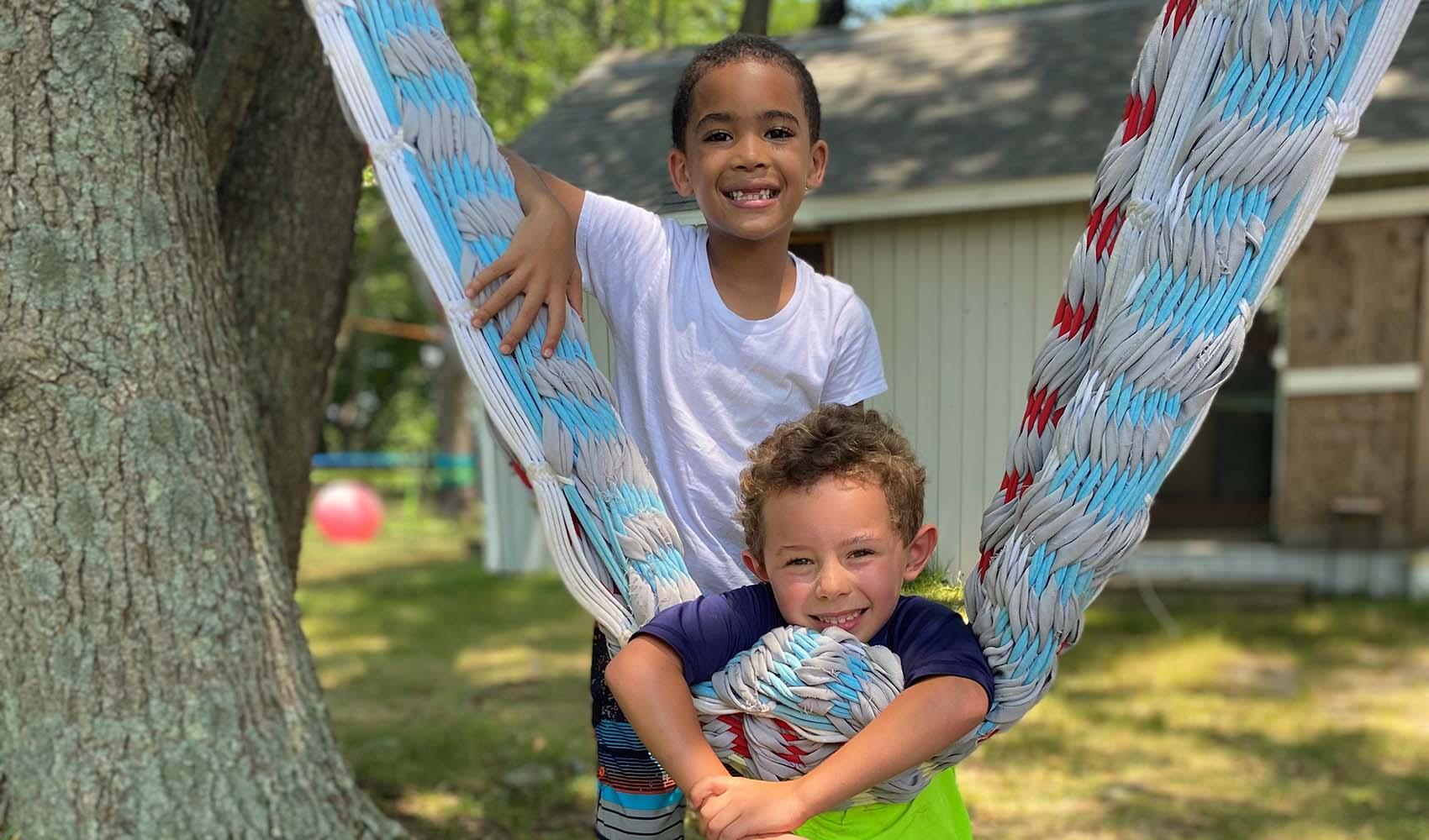 Campers next hammock smiling for camera