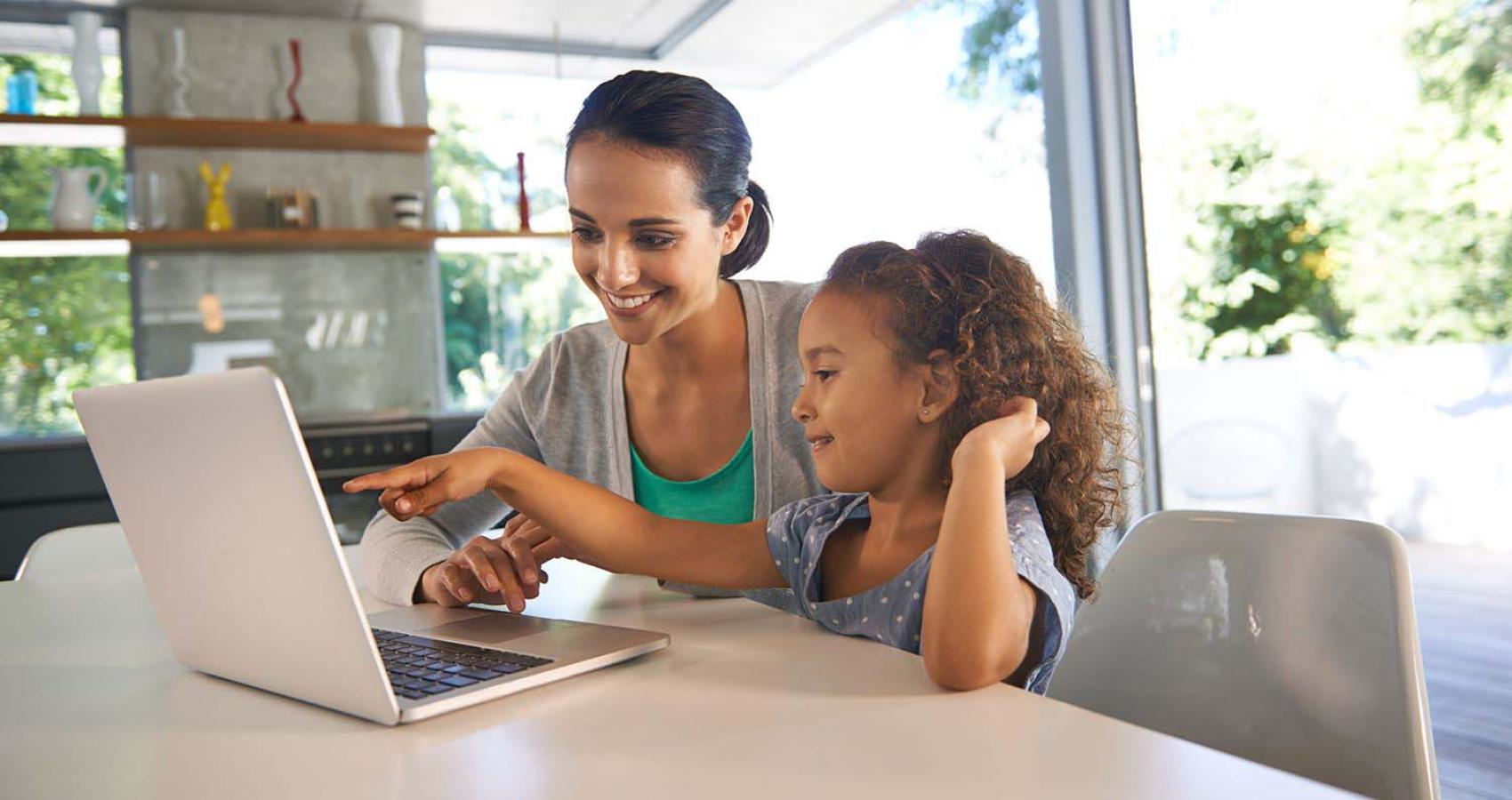 mom and daugher looking at laptop