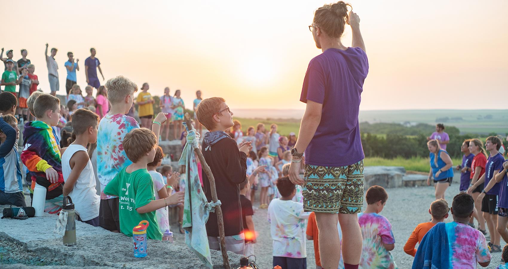 camp staff with campers at sunset