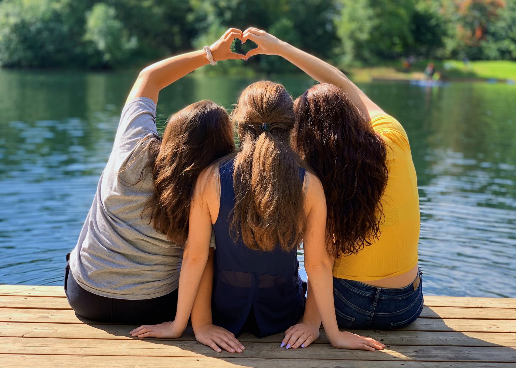 group of people making a heart with their hands