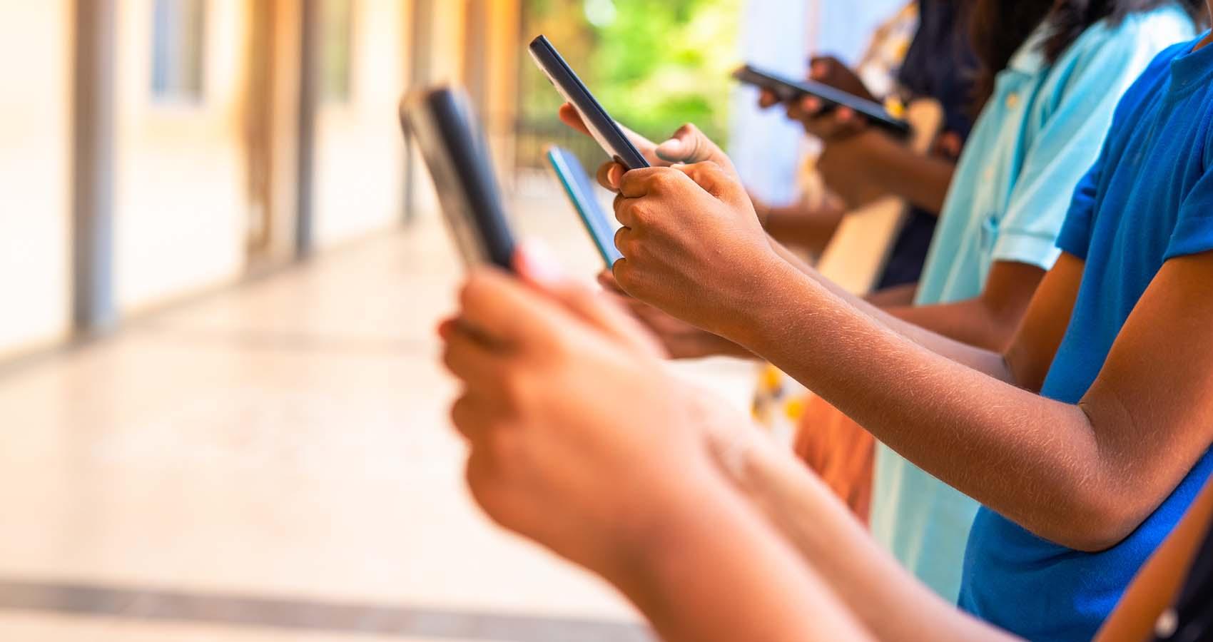 kids hands using smartphone