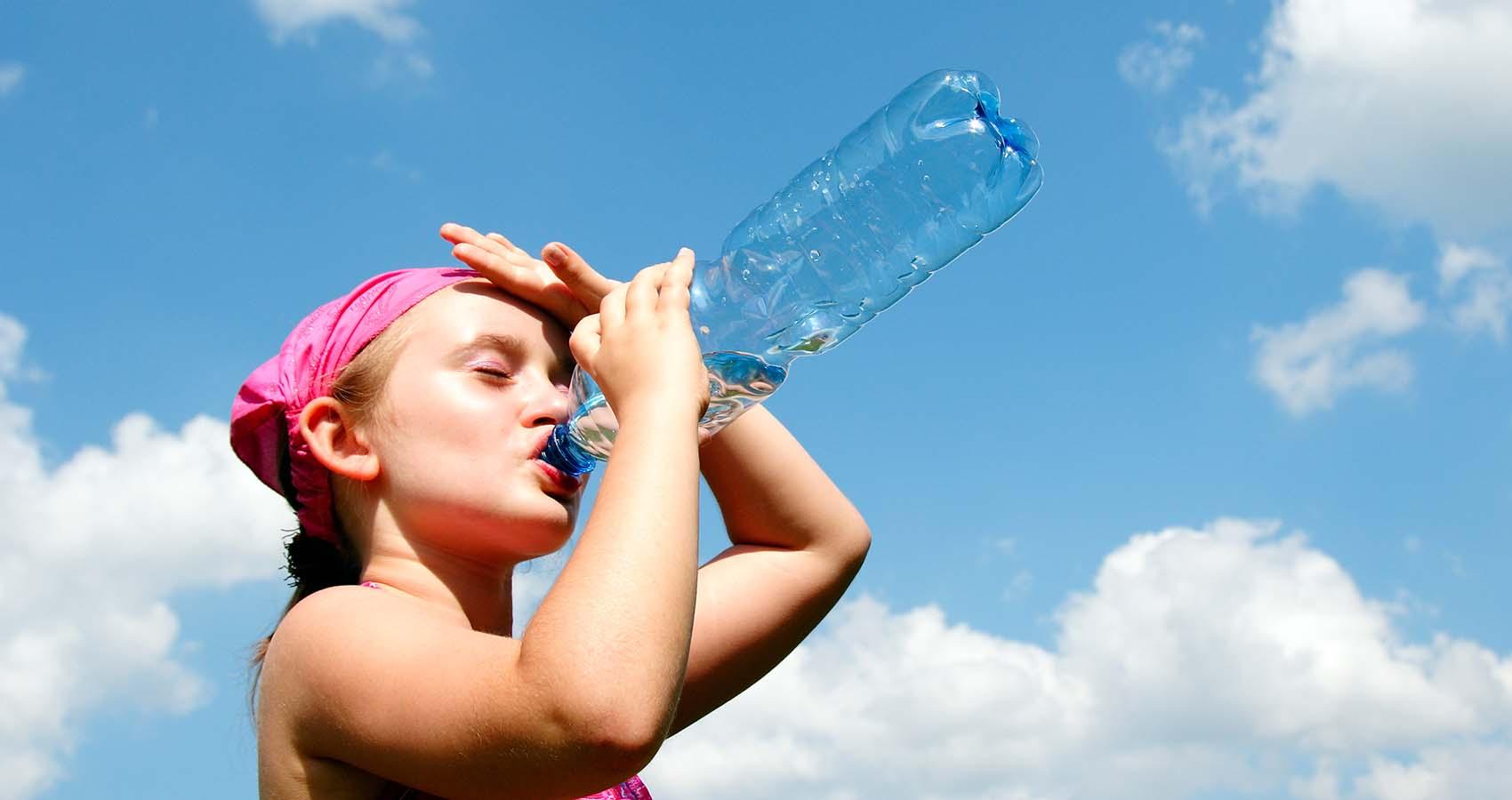 girl drinking from water bottle