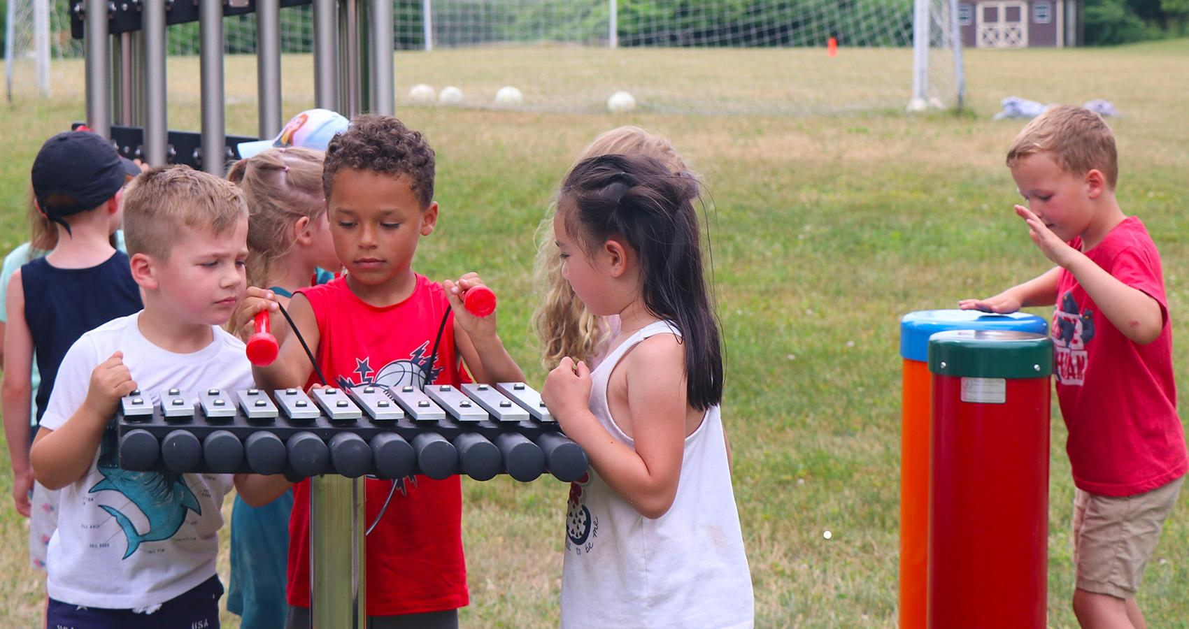 campers playing outdoor instruments